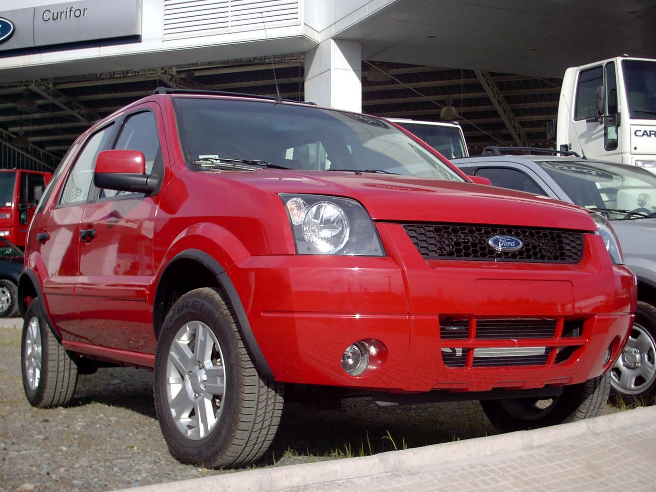 Front view of red SUV with bold grille and fog lights
