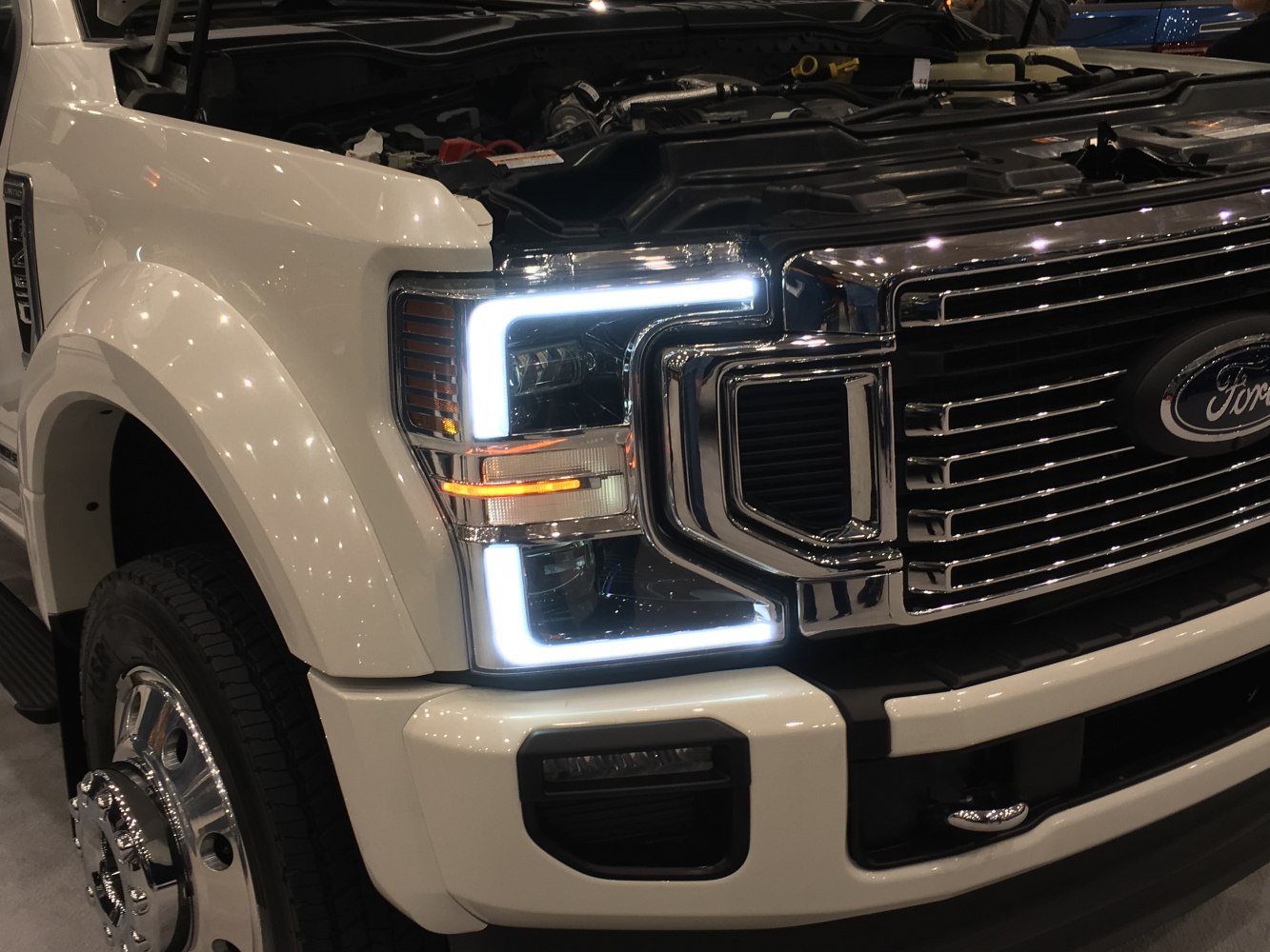 LED headlight and chrome grille close-up on heavy-duty truck front