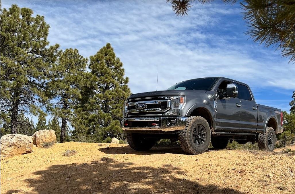 Heavy-duty pickup with crew cab and short bed on rugged off-road terrain