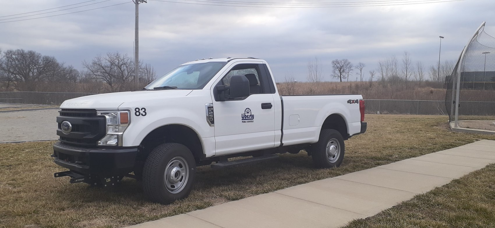 White regular cab long box pickup truck with 4x4 drivetrain and heavy-duty front design