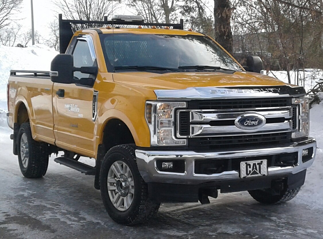 Yellow heavy-duty pickup with chrome grille and offroad tires