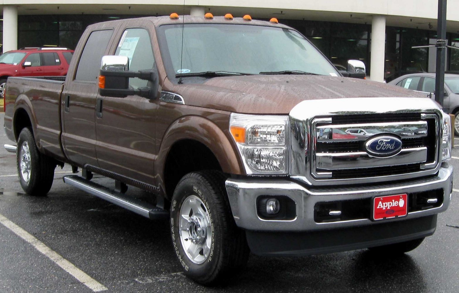 Front and side view of pickup with chrome grille and running boards