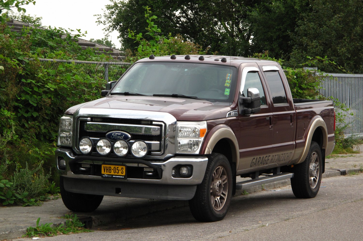 Ford pickup with chrome grille, four auxiliary front lights, crew cab, short box