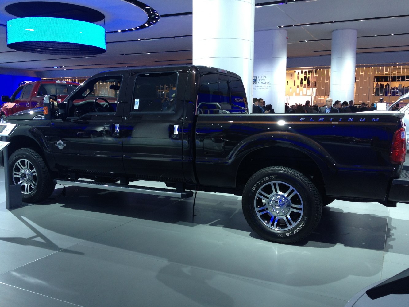 Black crew cab pickup with short cargo bed and platinum trim detailing.