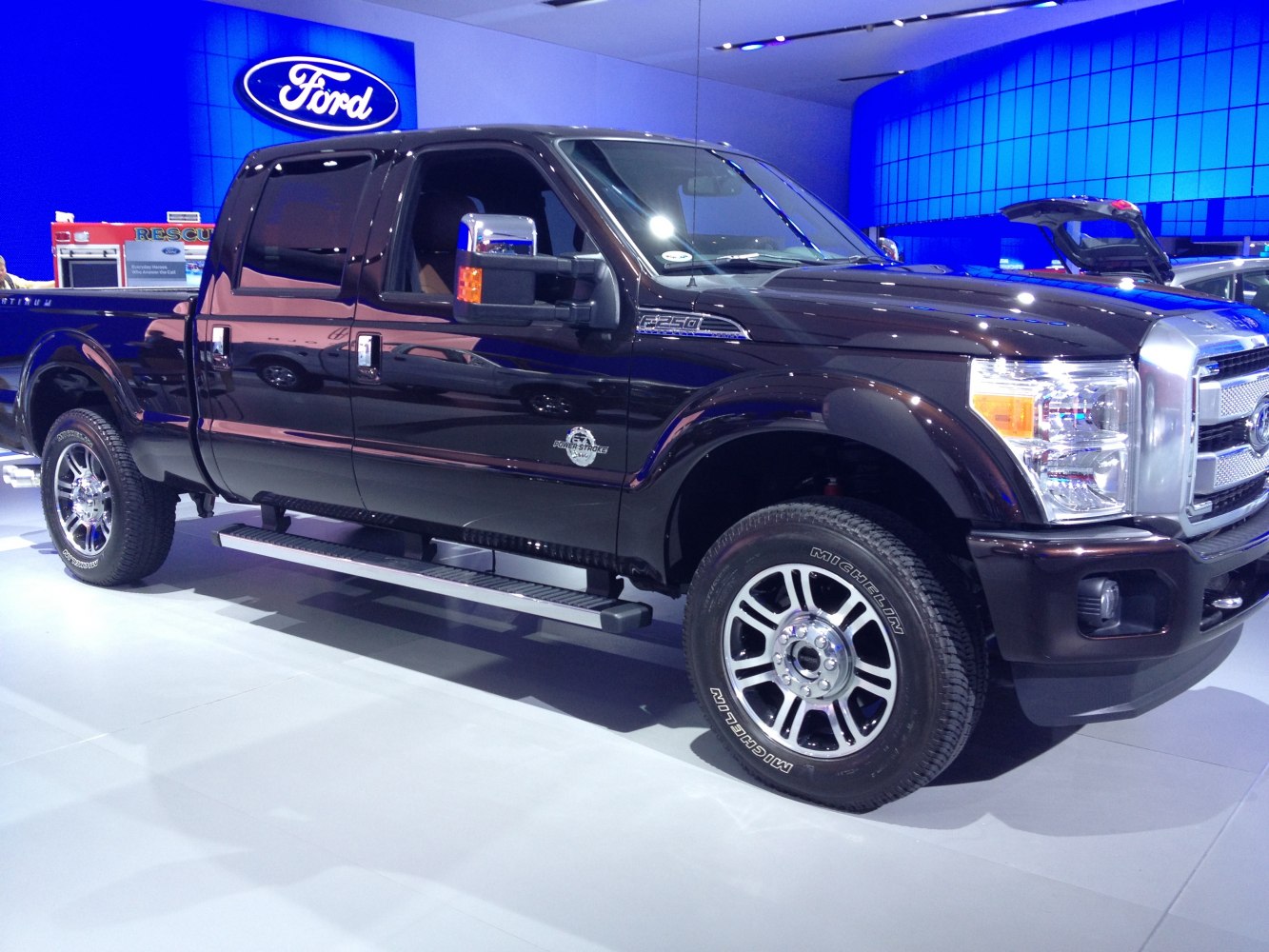 Black pickup truck with crew cab and short box, side view.