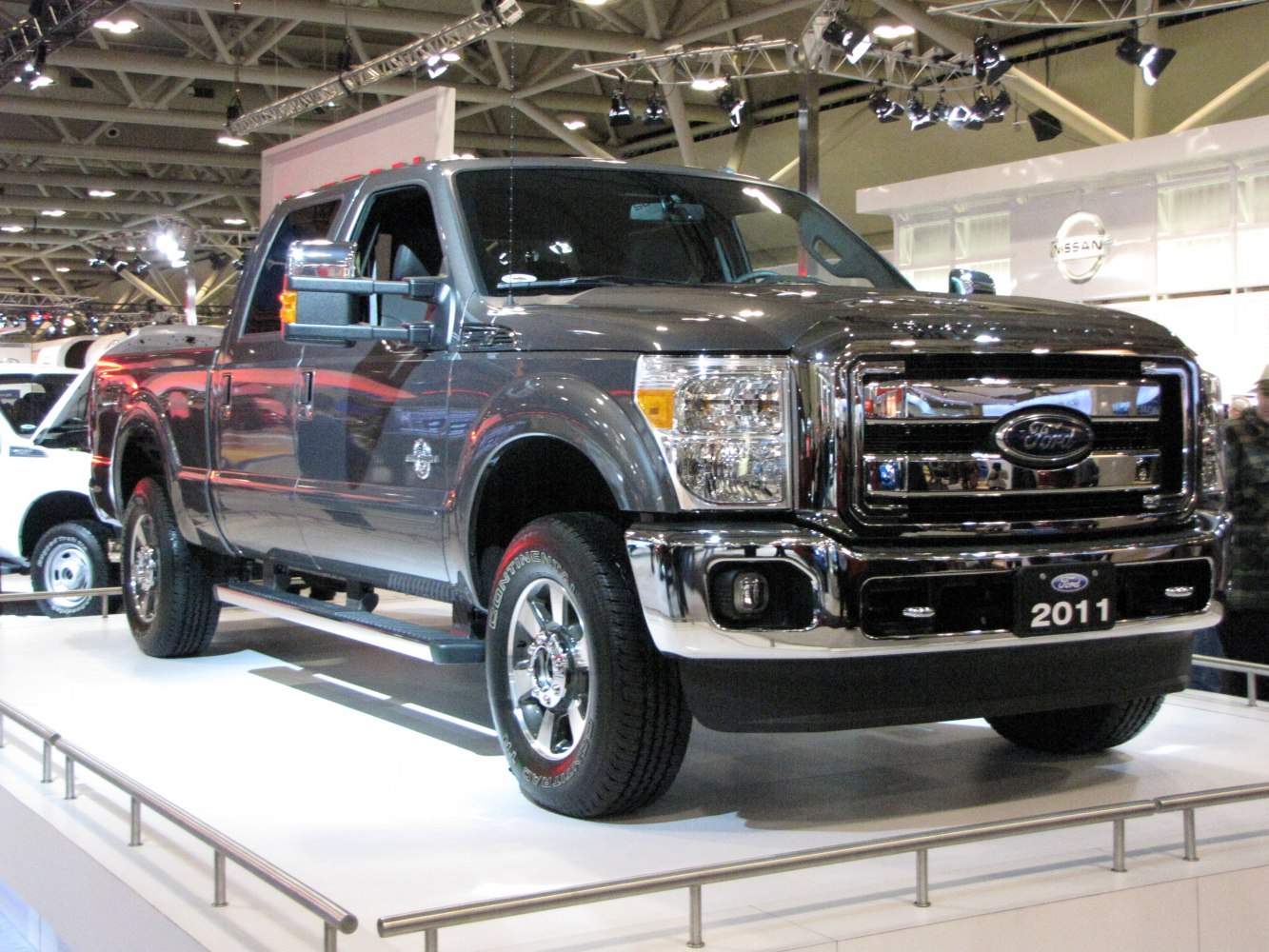 Front-side view of heavy-duty pickup truck with chrome grille and Crew Cab short box.