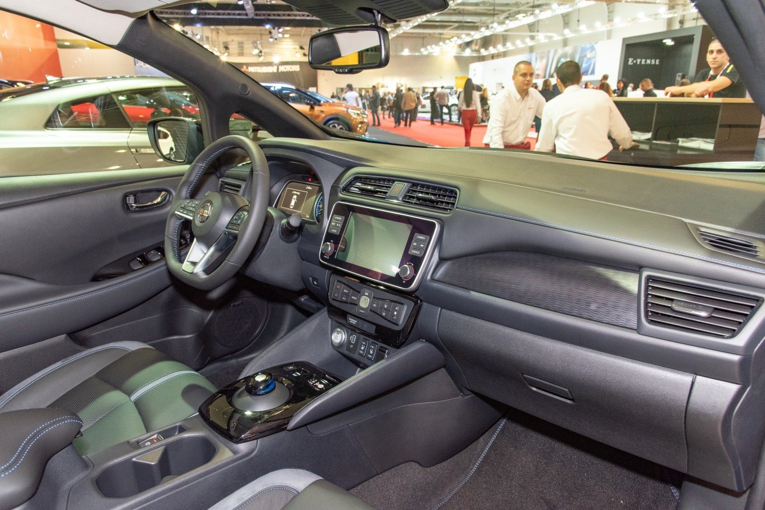 Modern electric vehicle dashboard with touchscreen and unique gear selector