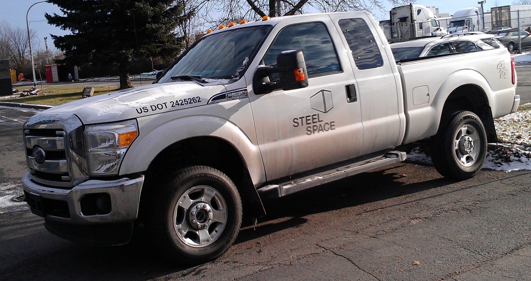 White extended cab pickup truck with short box and 4x4 decals