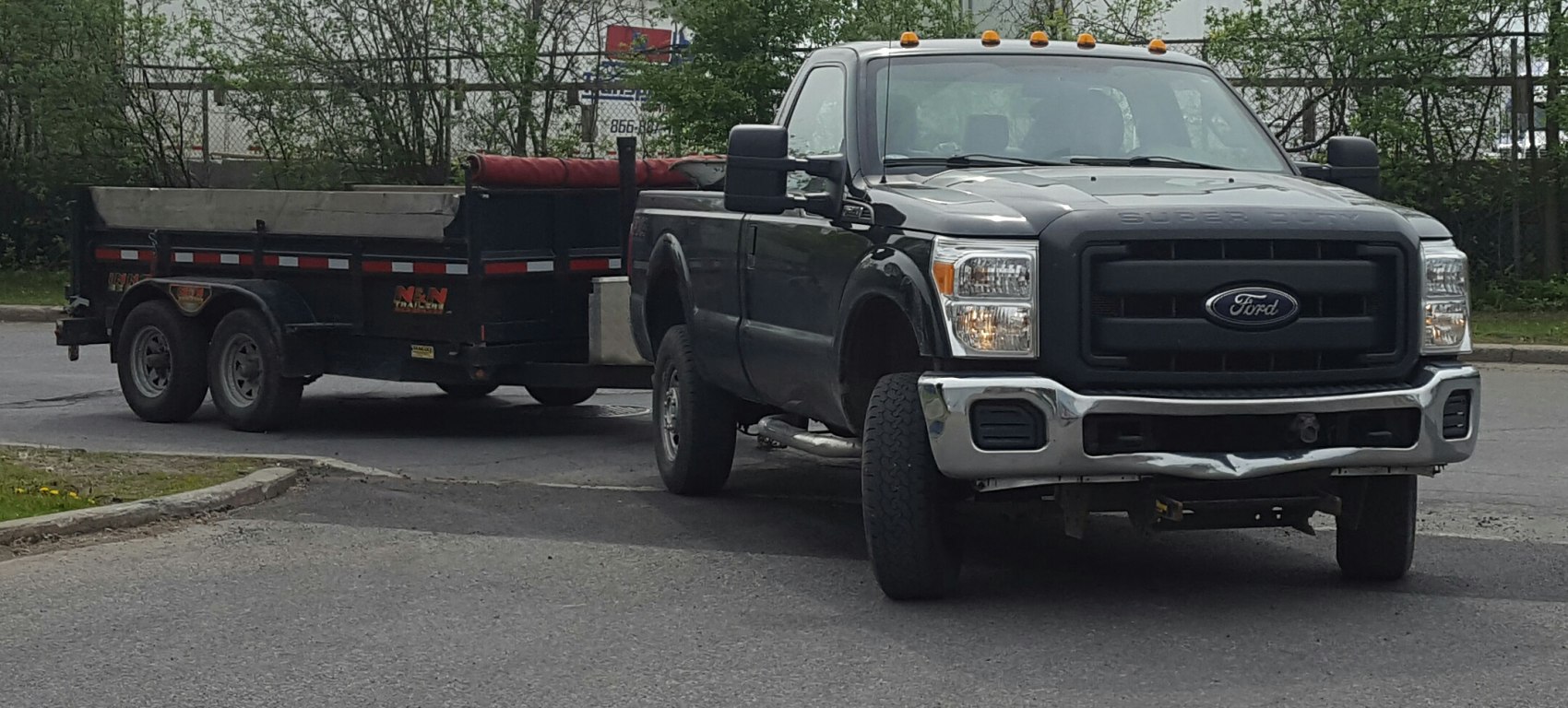 Pickup truck towing a heavy-duty dual-axle utility trailer