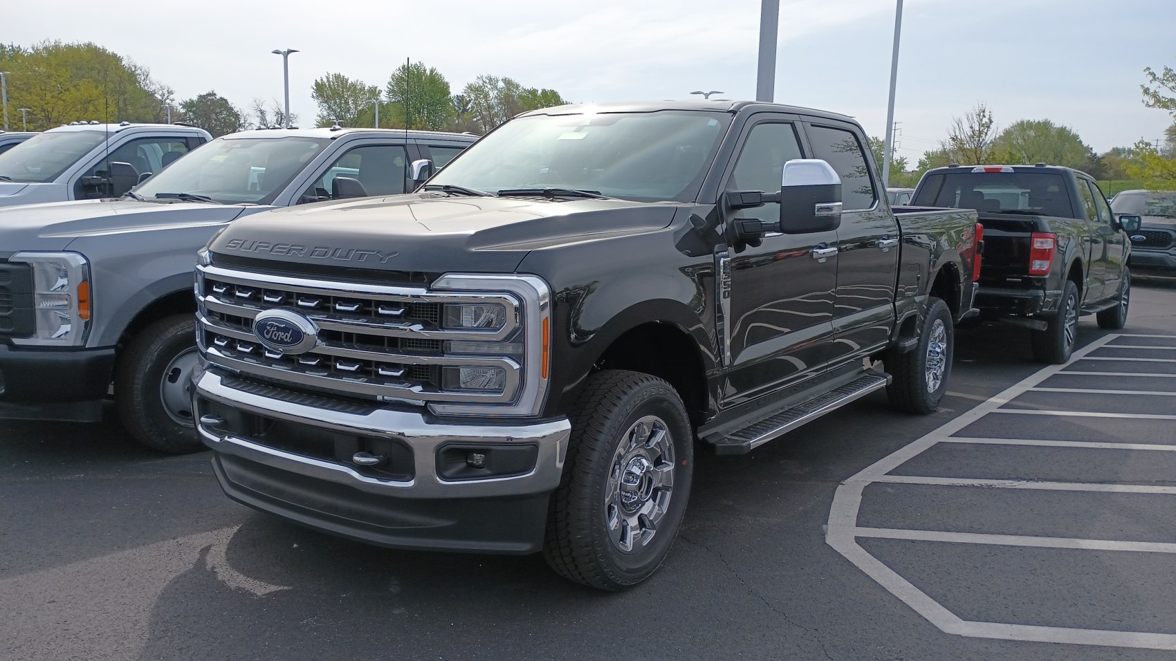 Heavy-duty pickup with crew cab and short box, bold grille, chrome bumpers