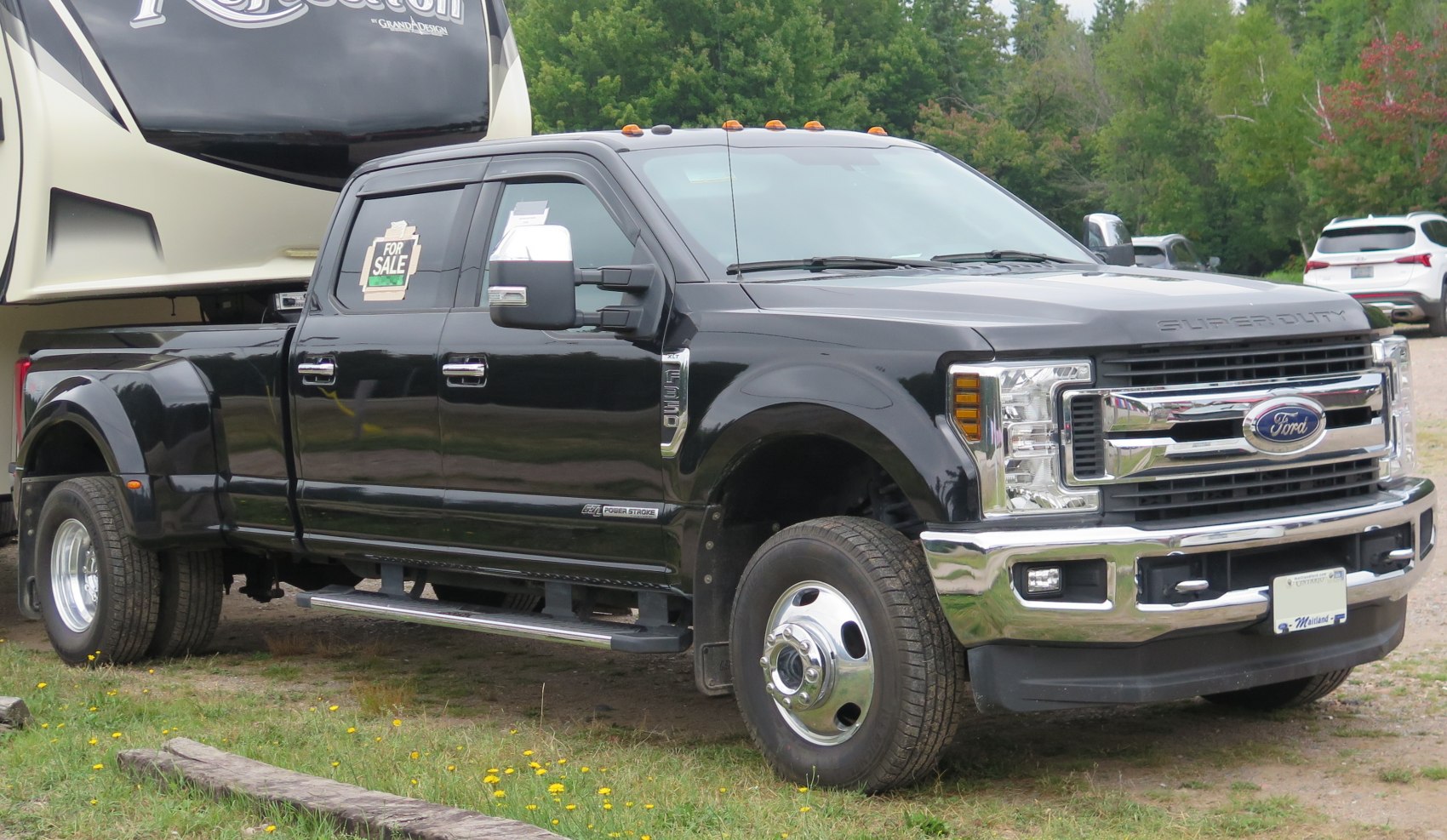 Heavy duty pickup with crew cab, long box, dual rear wheels, and chrome accents