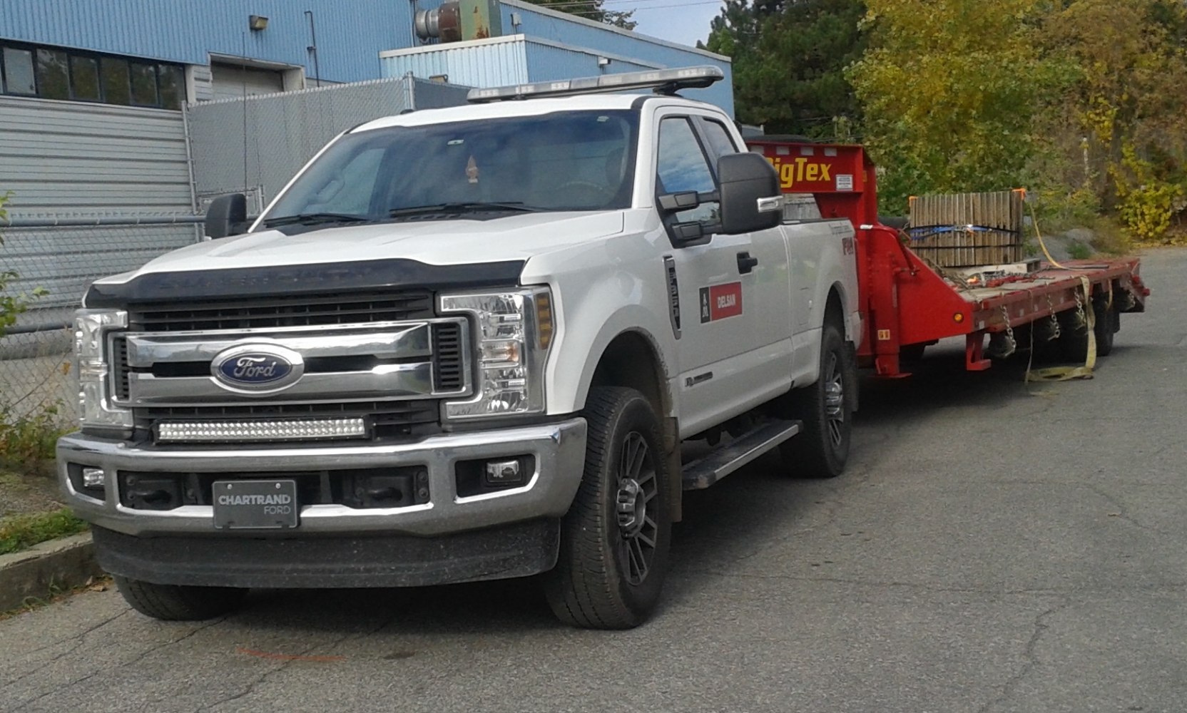 Heavy-duty pickup towing a large trailer with Super Cab and short bed
