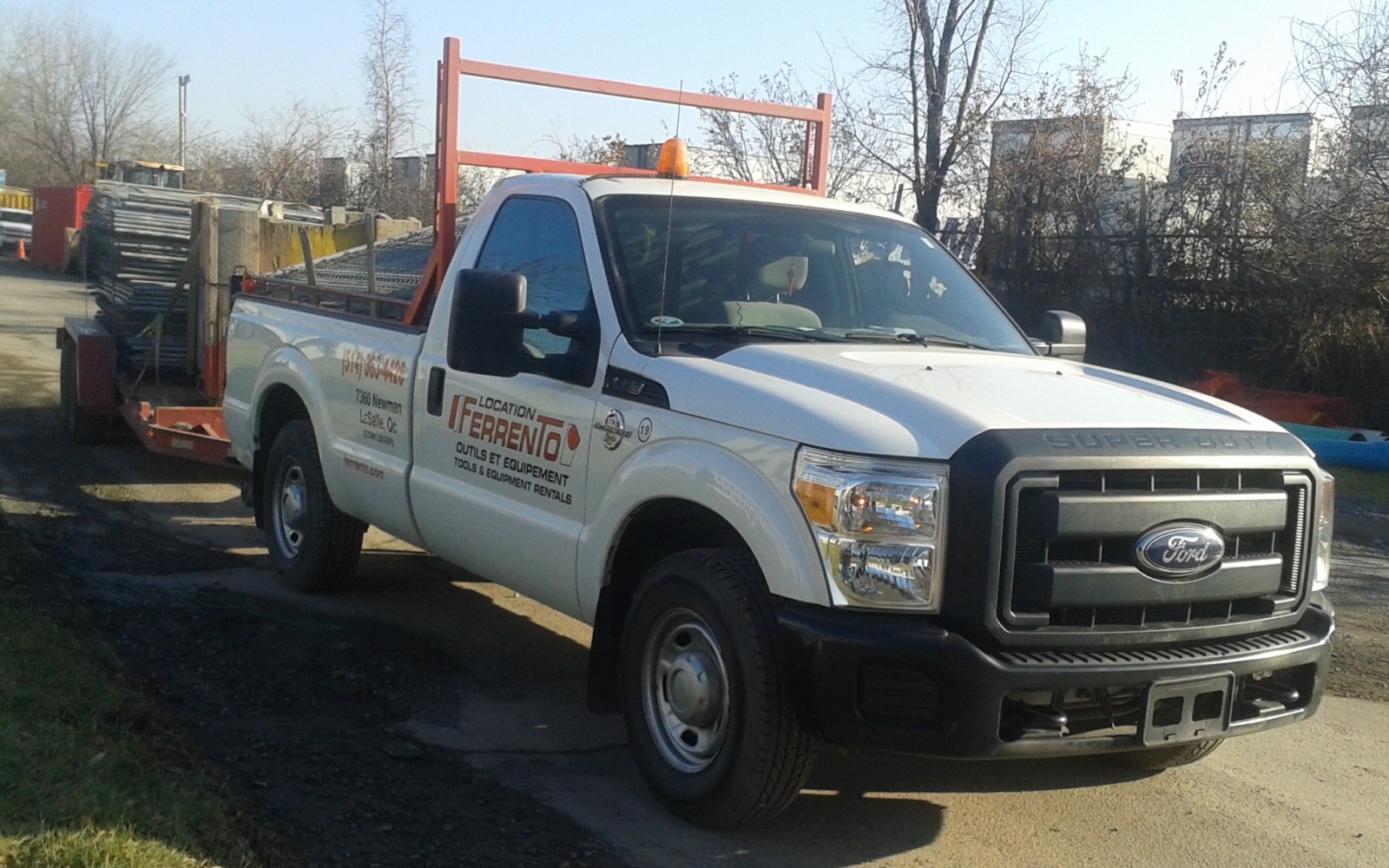 Heavy-duty pickup with regular cab and long flatbed transporting metal scaffolding