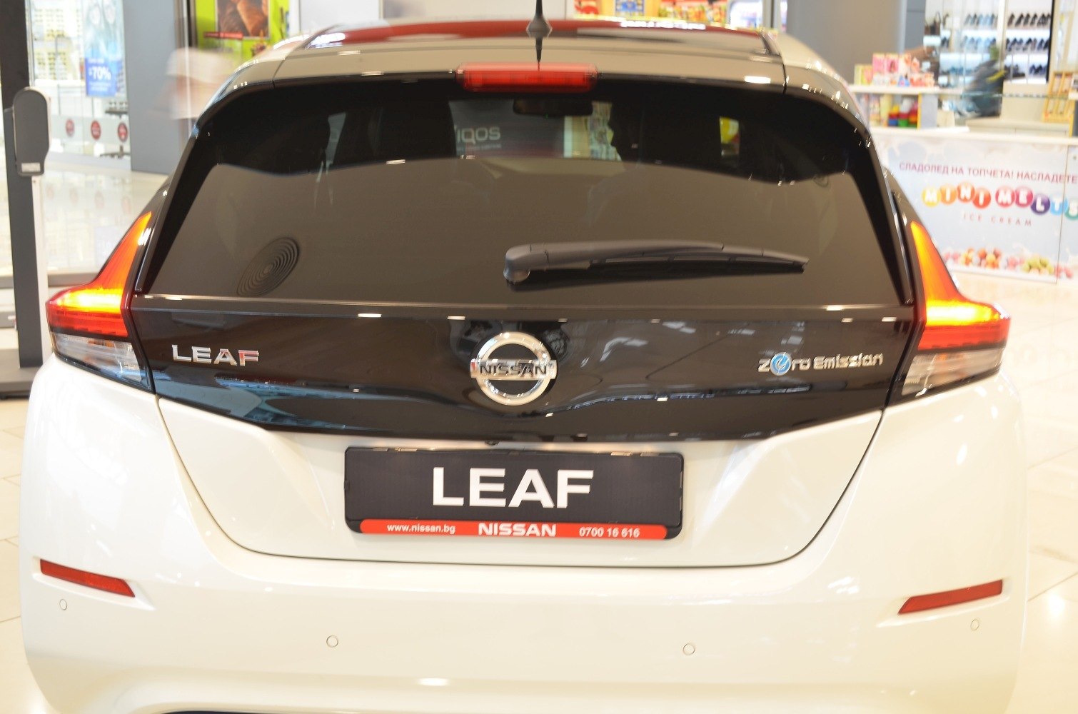 Rear view hatchback with distinctive tail lights and rear windshield wiper