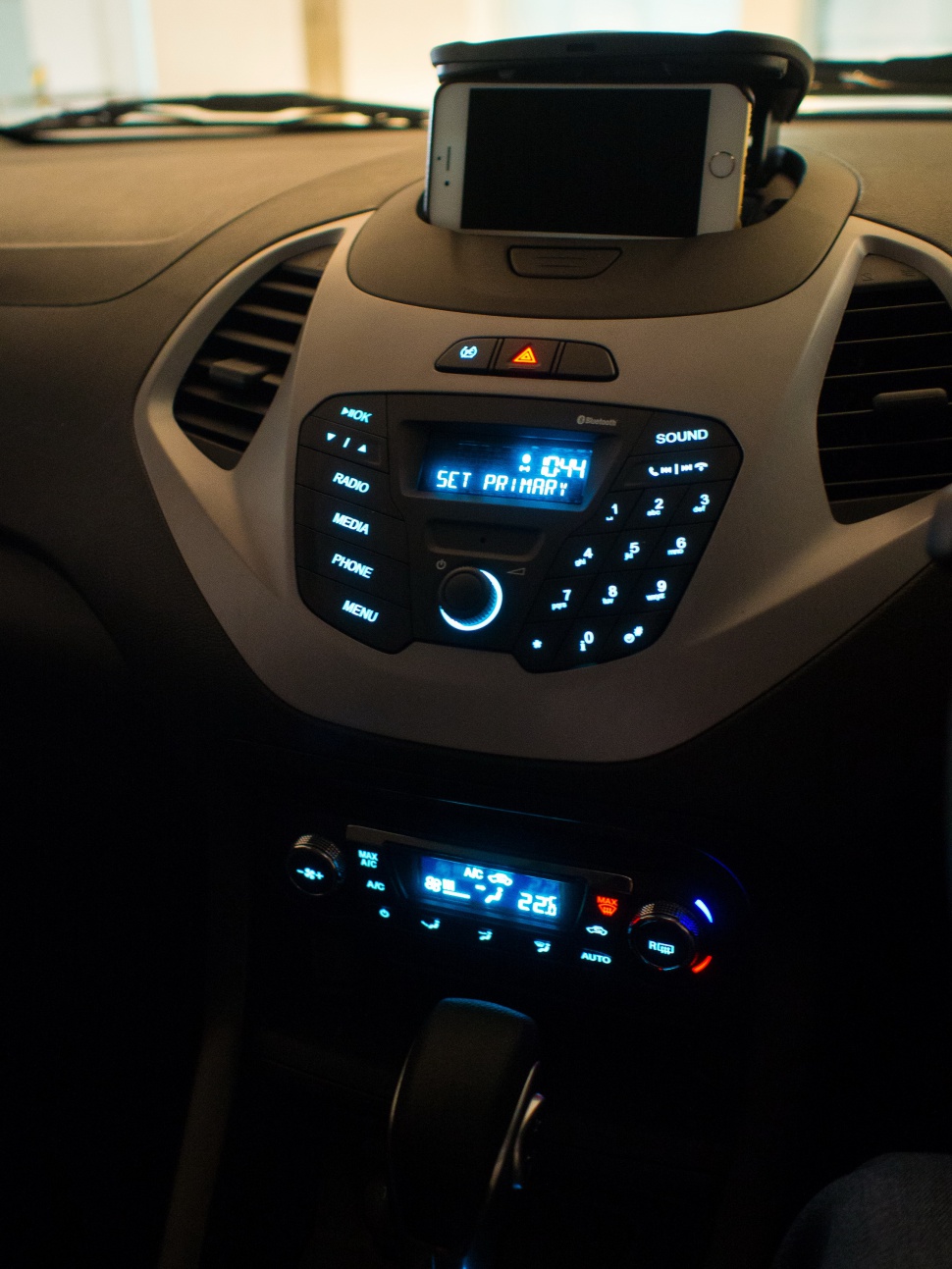 Illuminated car dashboard center console with Bluetooth and climate control
