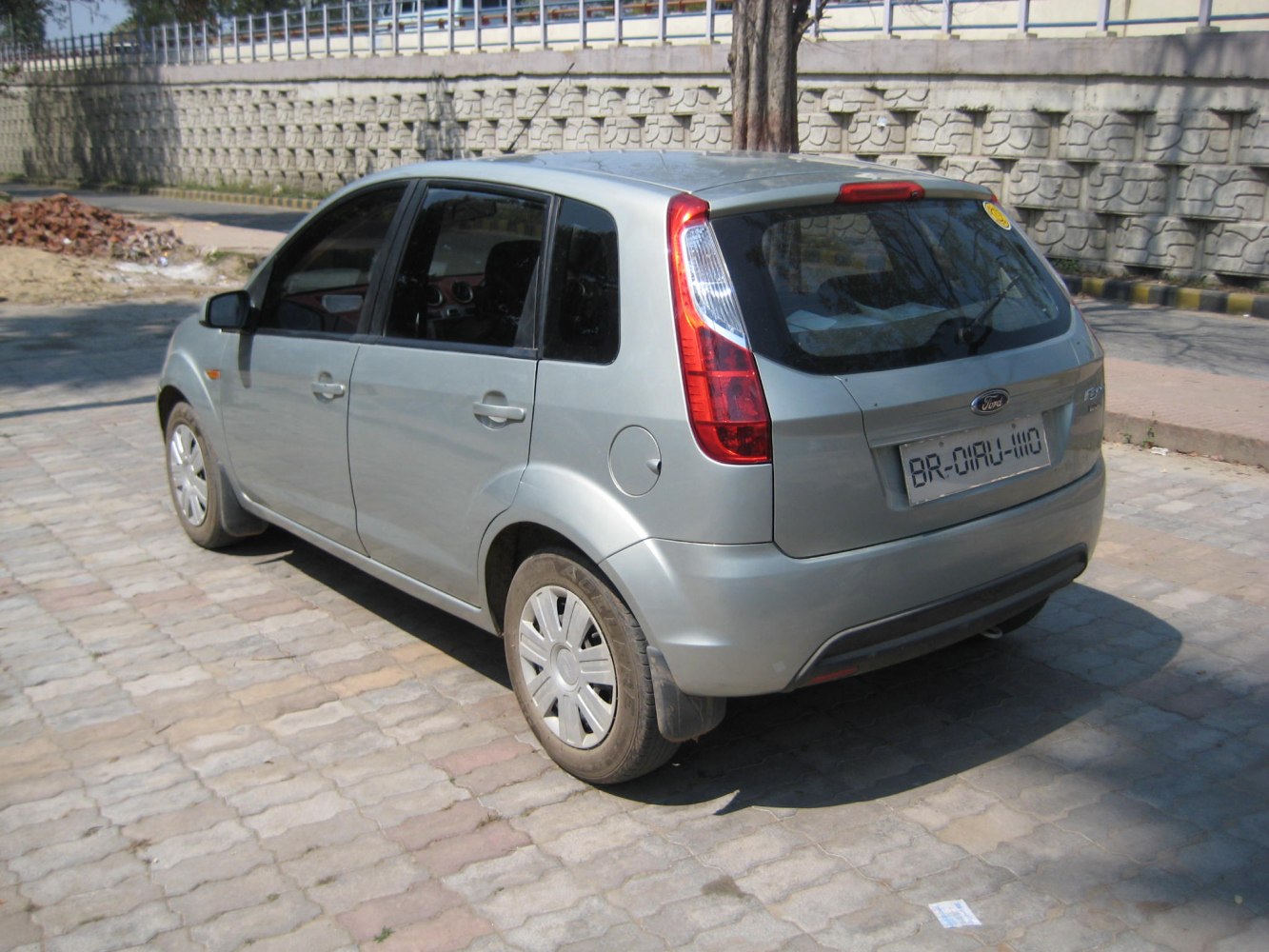 Silver hatchback car rear and side view with distinct taillights