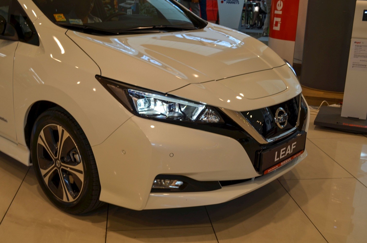 Sleek front close-up with distinctive headlights and alloy wheel.