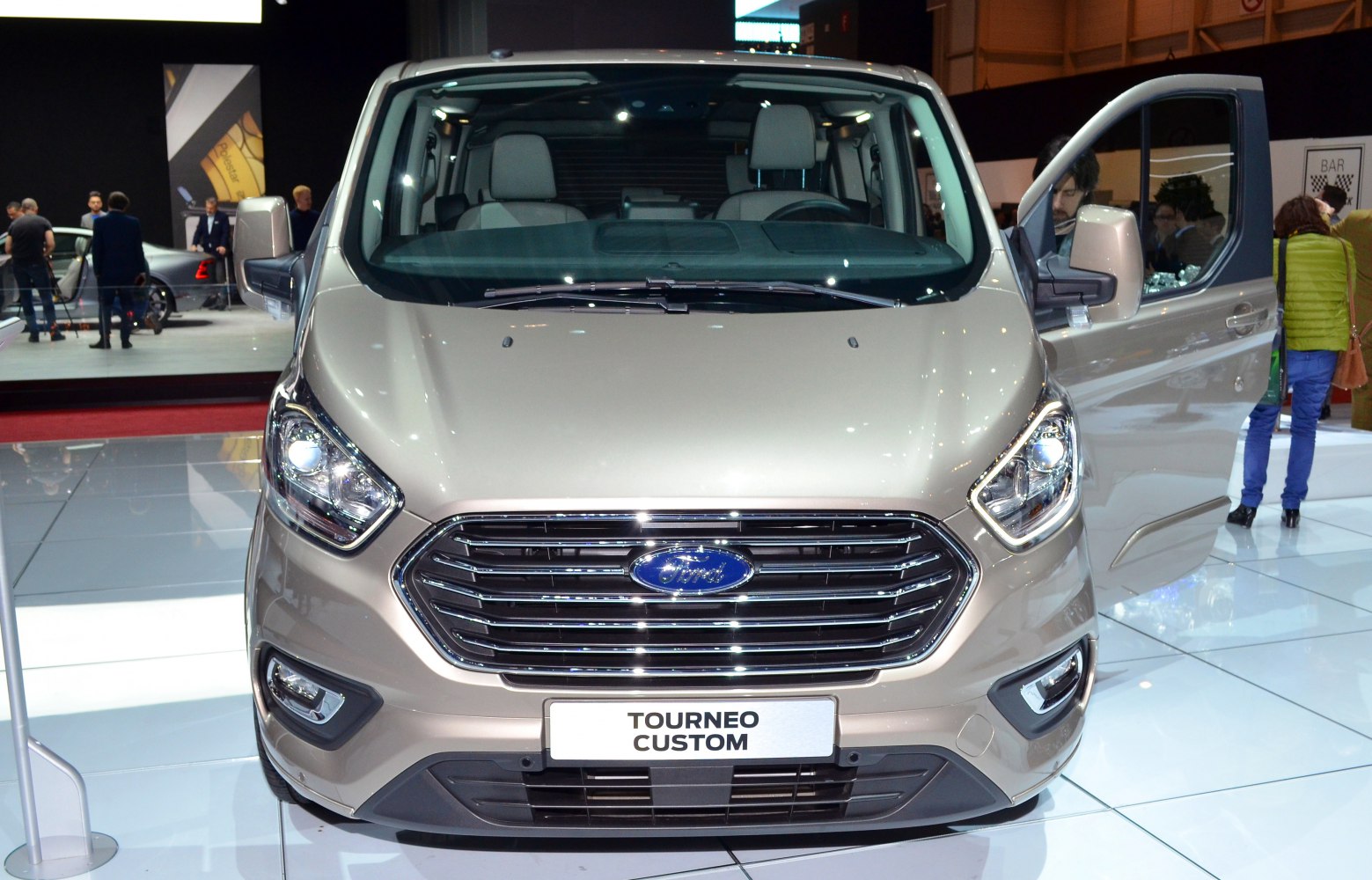 Front view with grille, headlights, and open driver door