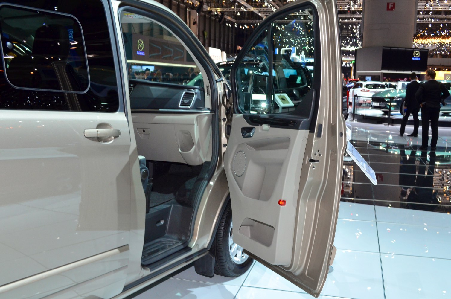 Passenger front door fully open showing beige interior and dashboard