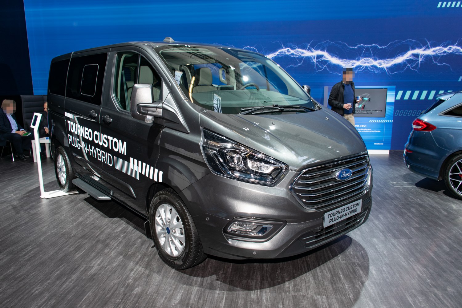 Front view of a modern van with sleek grille and headlights