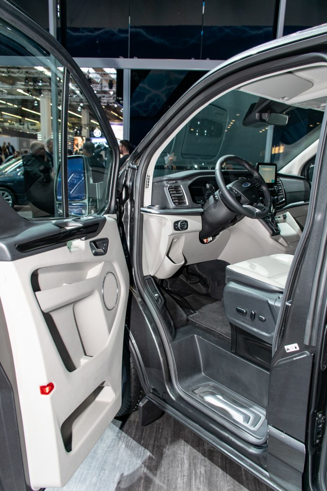 Open front door and driver cockpit interior with seats