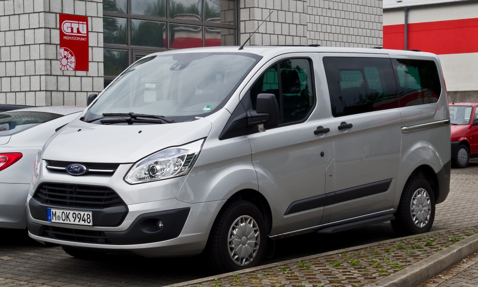 Silver passenger van front-side view with sliding door and black trim