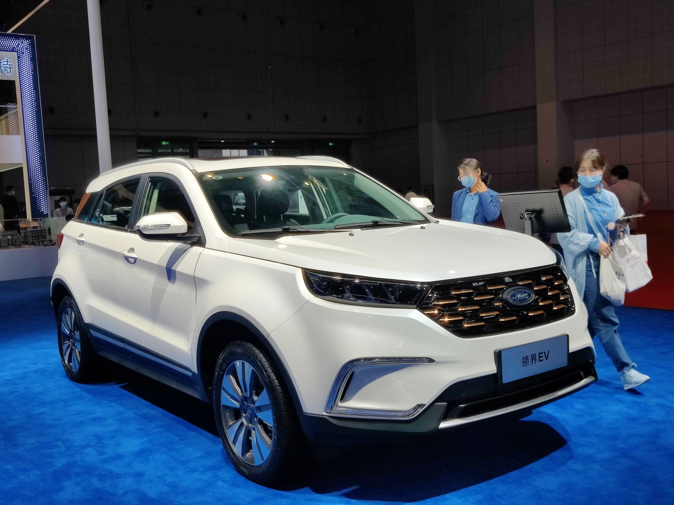 White SUV front side profile with bold grille and modern headlights