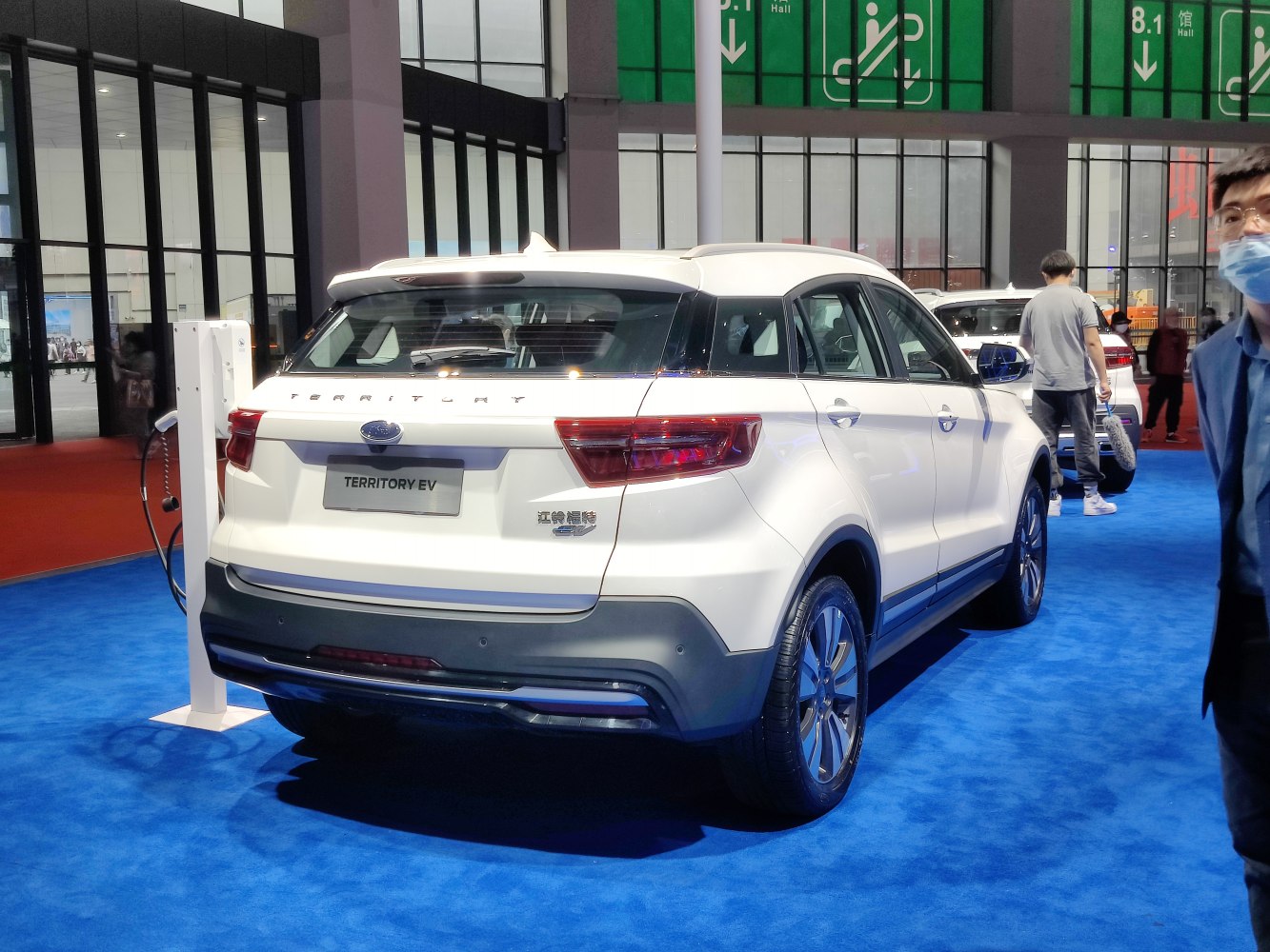 Rear side view of electric SUV with visible charging port