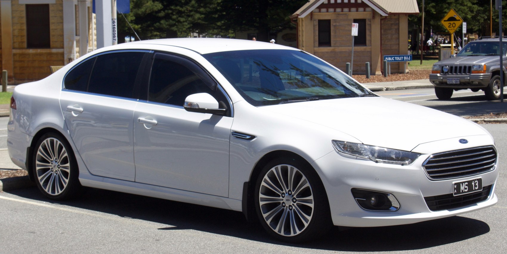 White modern sedan with chrome grille and alloy wheels