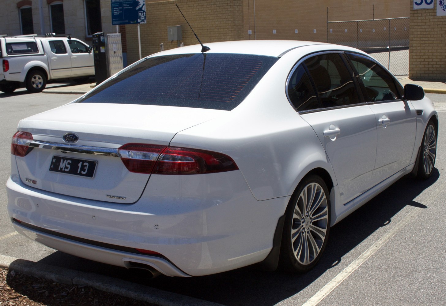 Rear view with taillights, dual exhaust, alloy wheels