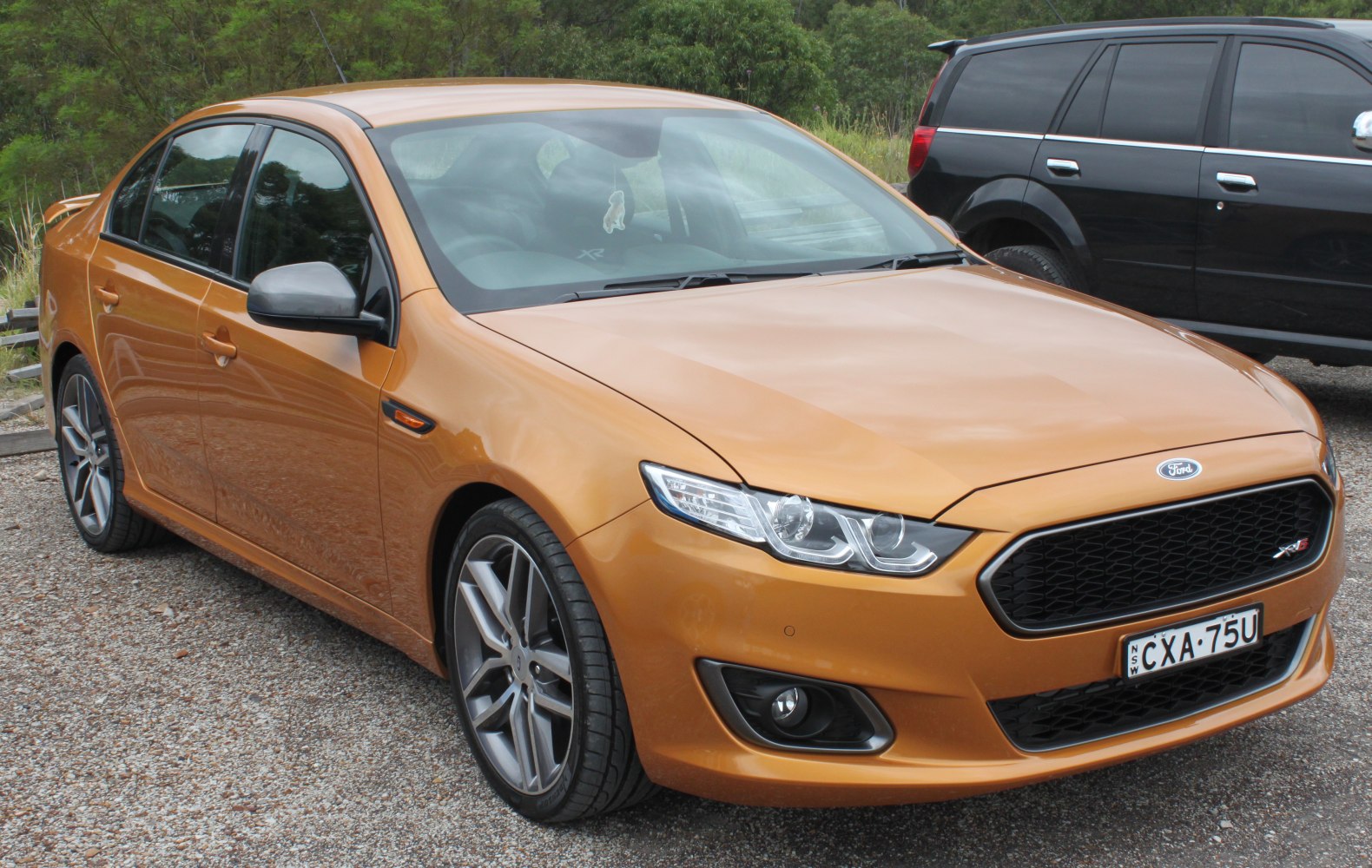 Sporty sedan with aggressive front grille and alloy wheels