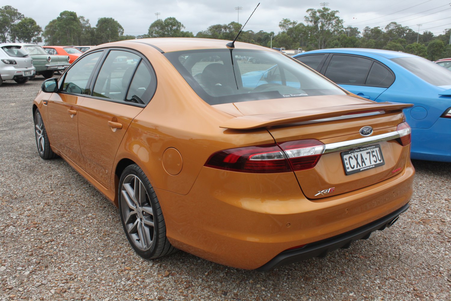 Rear view of a sedan with spoiler and alloy wheels