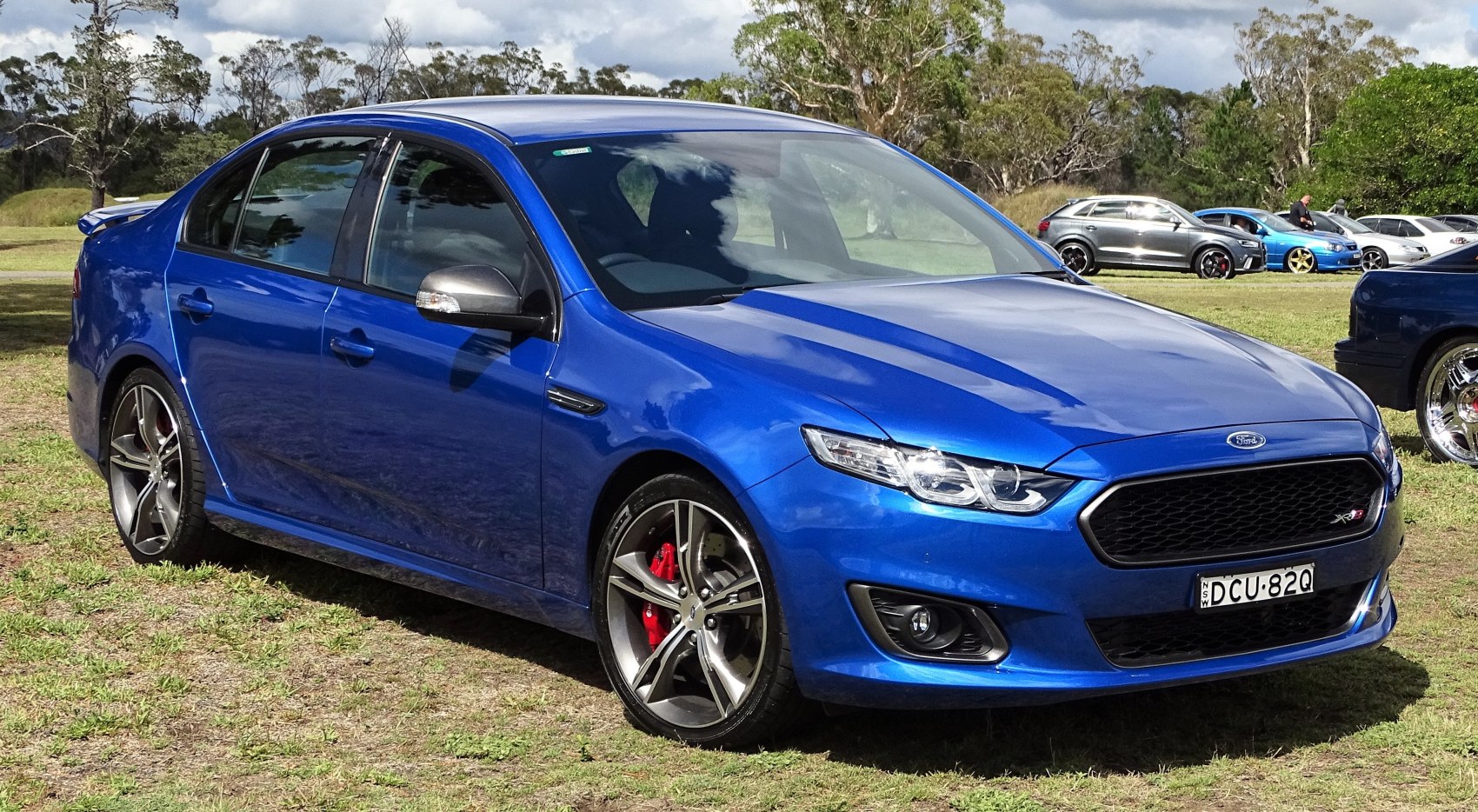 Blue sedan with sport alloy wheels and red brake calipers