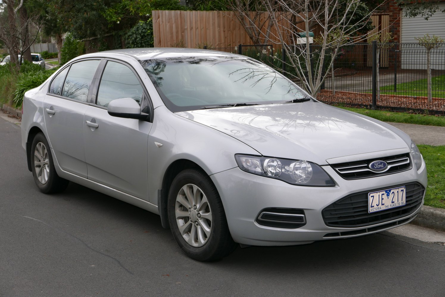 Silver sedan with dual headlights and front grille