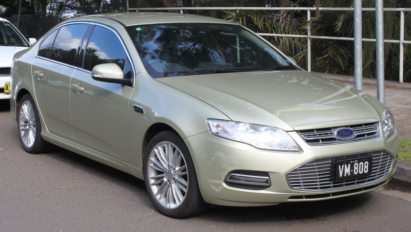 Silver sedan with alloy wheels and distinct front grille headlights
