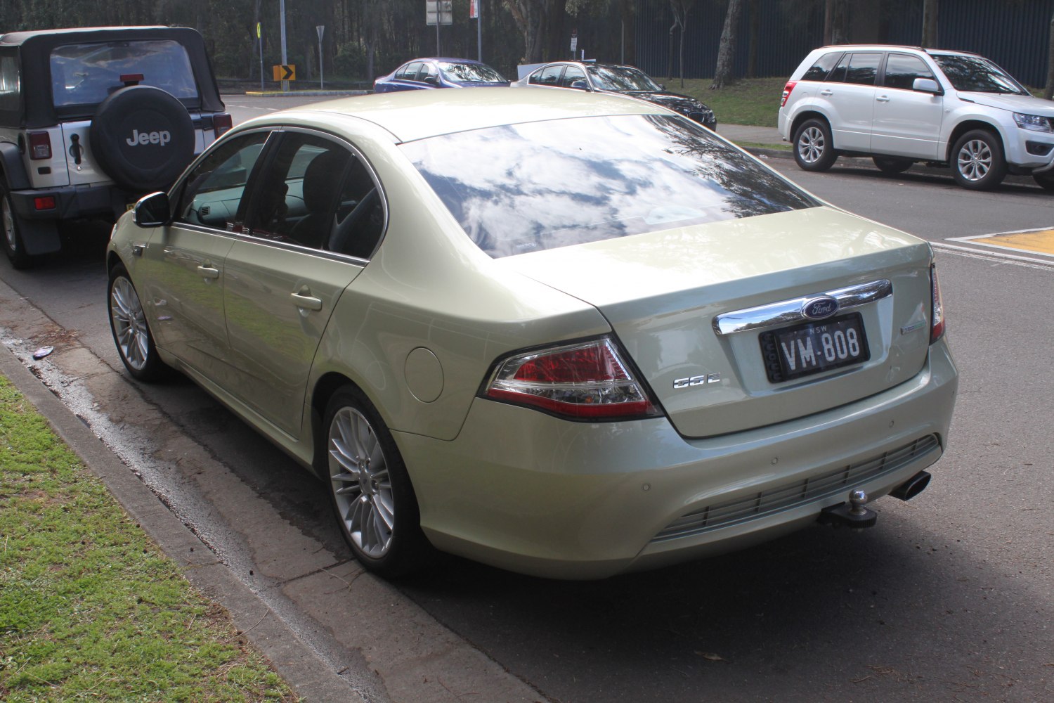 Rear view of a sedan with distinctive tail lights and chrome trim