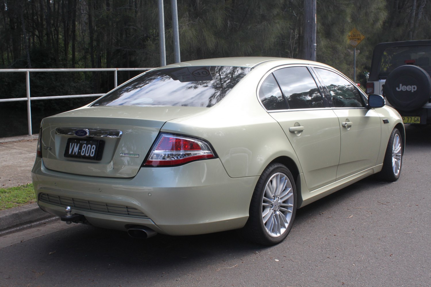 Rear view of a sedan with alloy wheels and taillights
