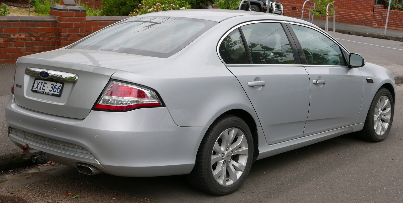 Silver sedan rear side with distinct taillights and alloy wheels