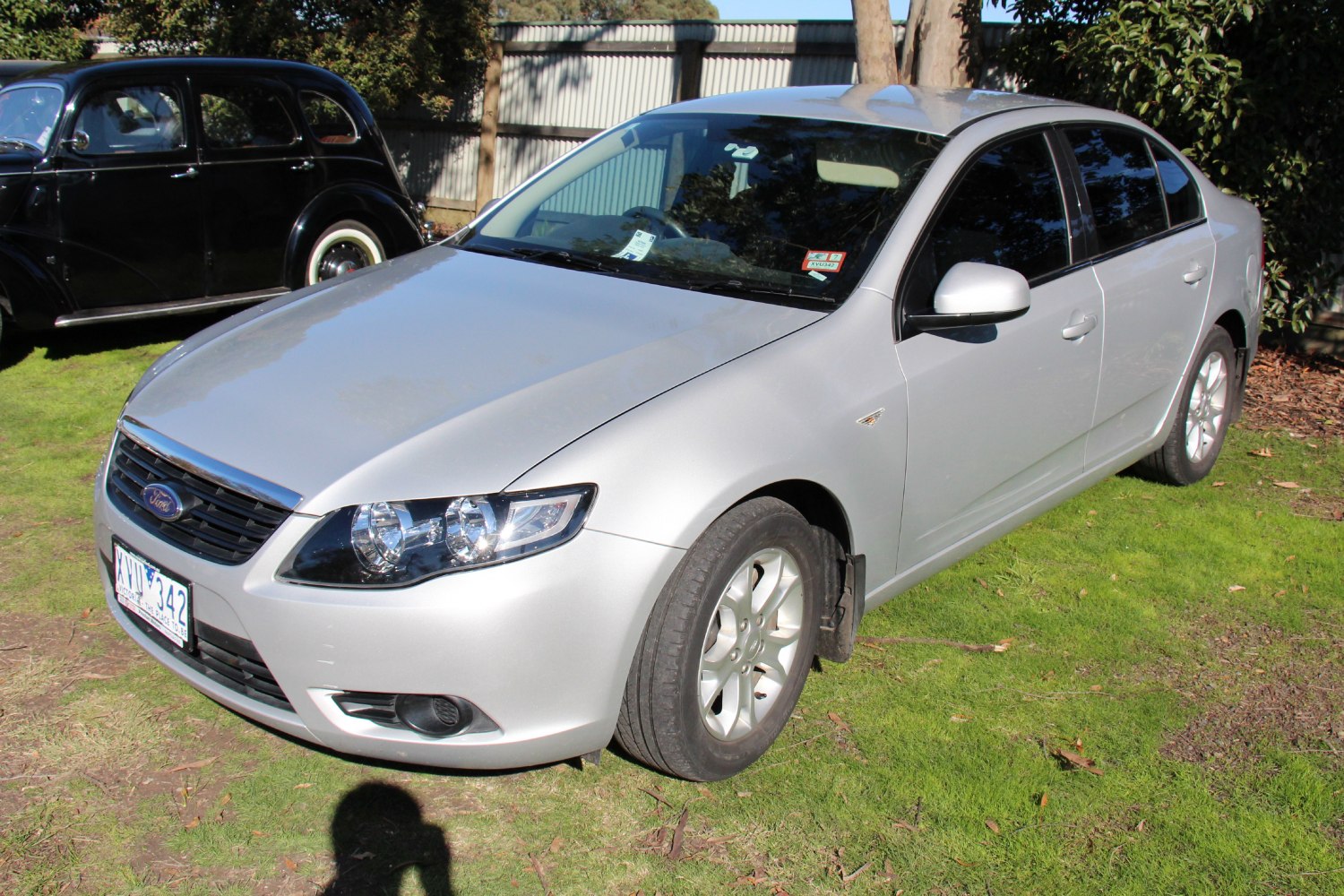 Silver sedan with front and side view, clear headlights and grille