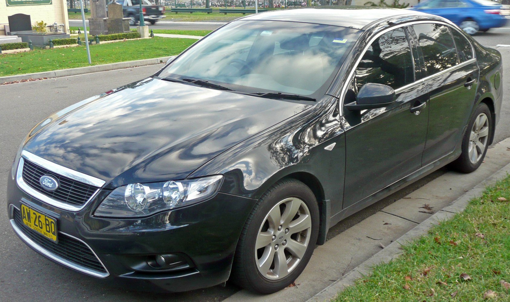 Black sedan front-left exterior with distinctive grille and headlights