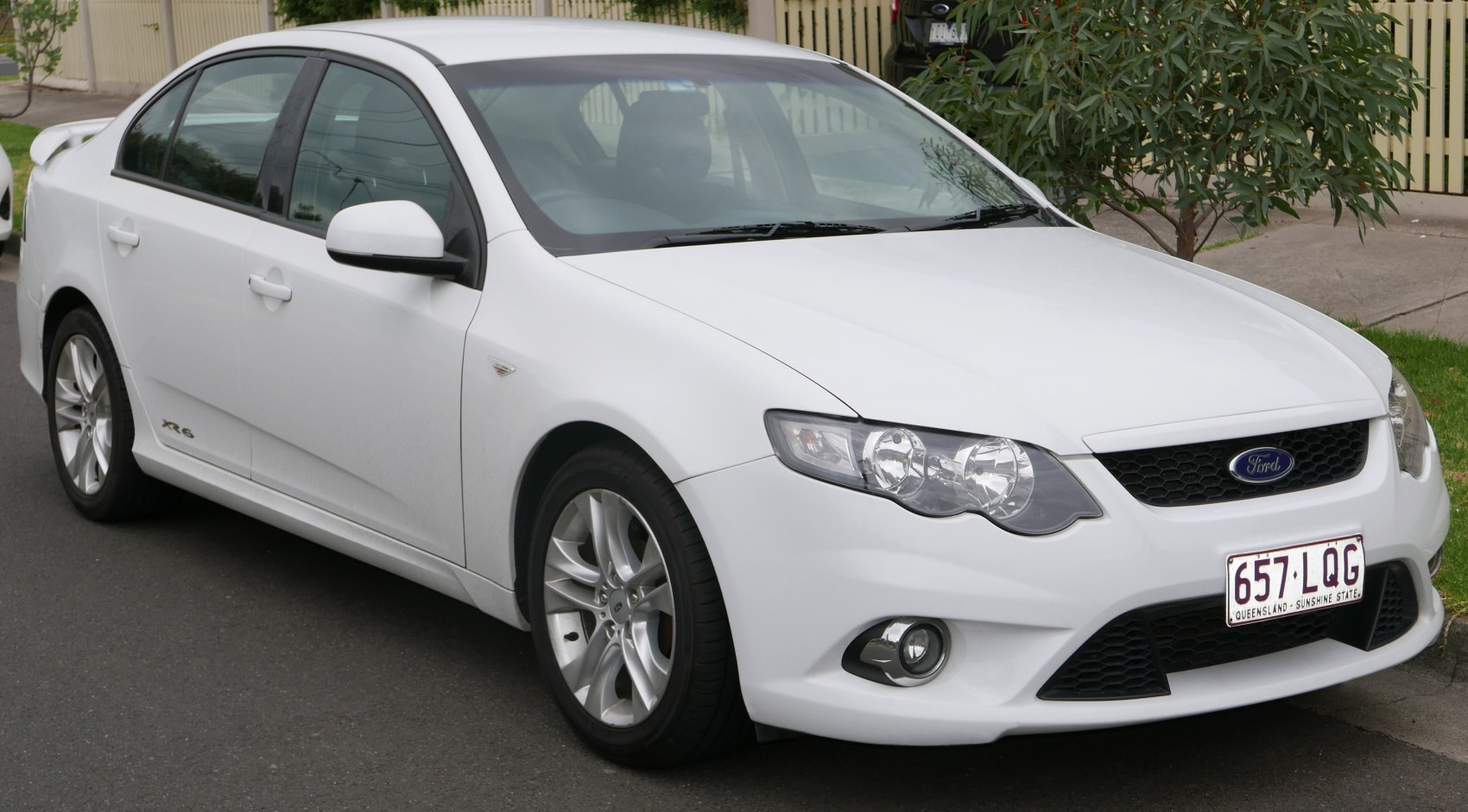 White sedan with sleek headlights and chrome alloy wheels