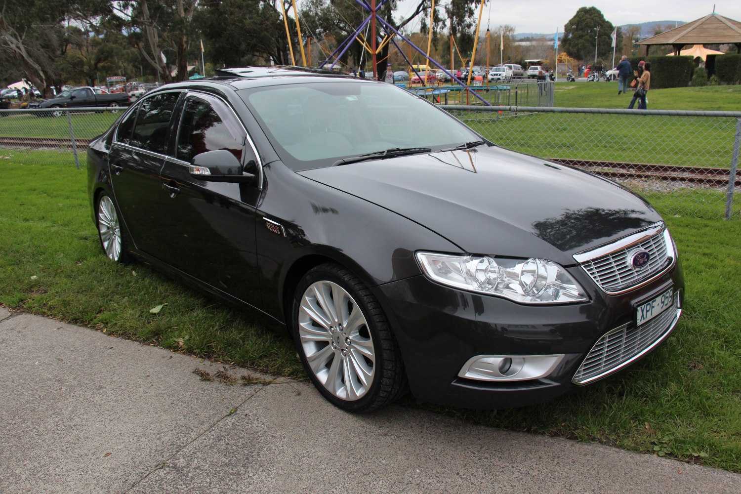 Black sedan with chrome grille and alloy wheels front side view