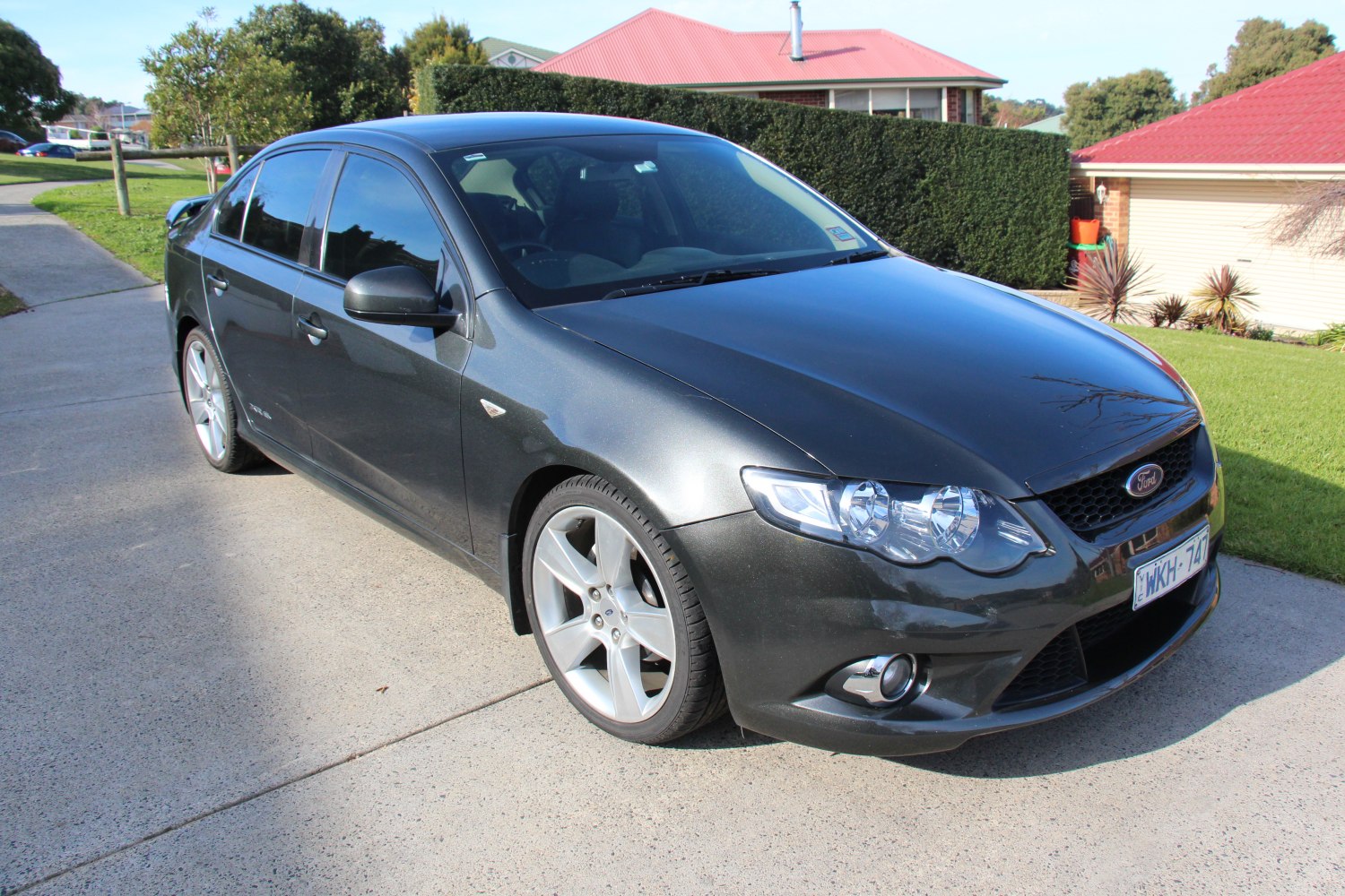 Black sedan with alloy wheels and dual headlights