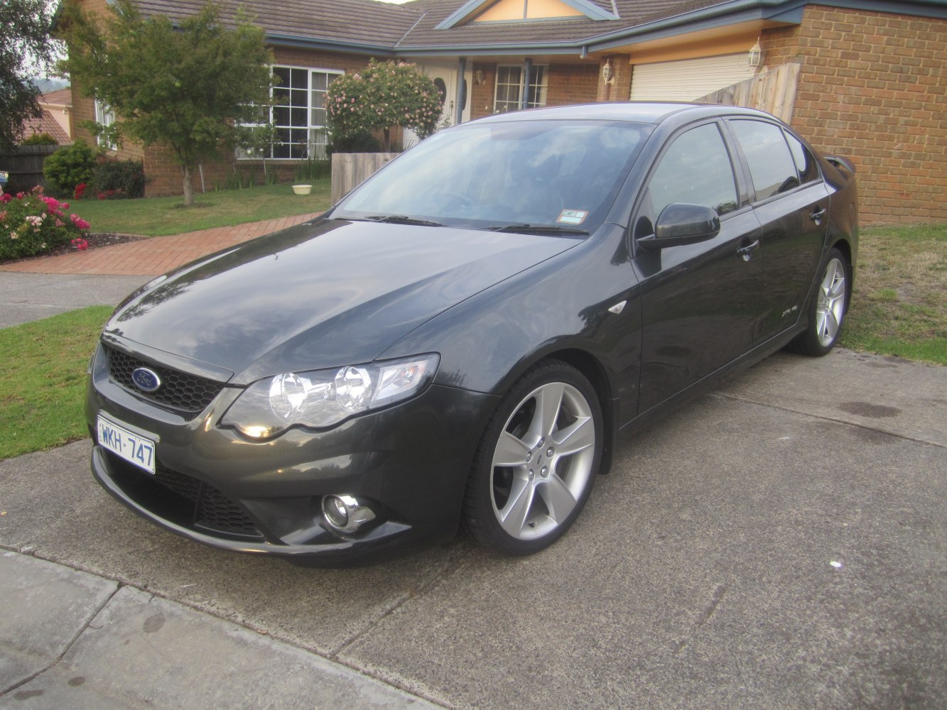 Black sedan with alloy wheels and fog lights