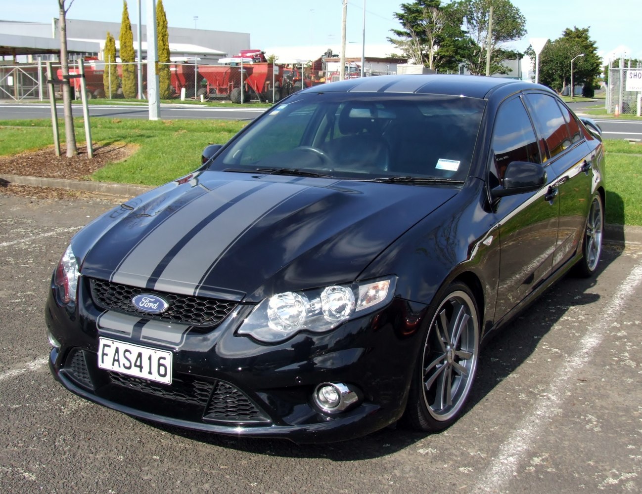 Sporty front with dual racing stripes and alloy wheels