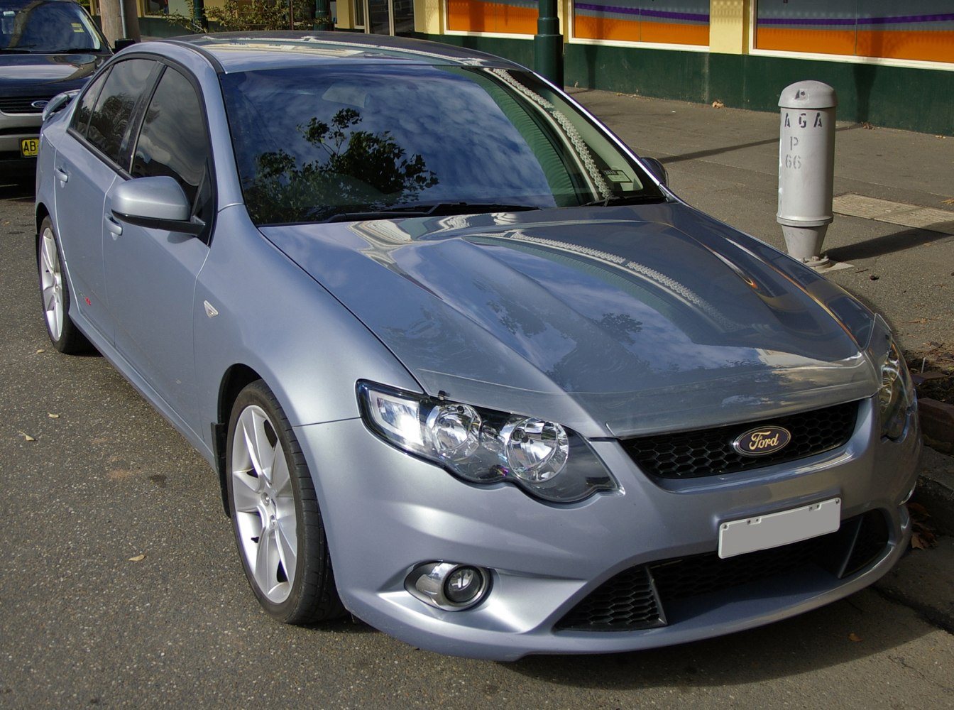 Front-side view of silver sedan with modern headlights and alloy wheels