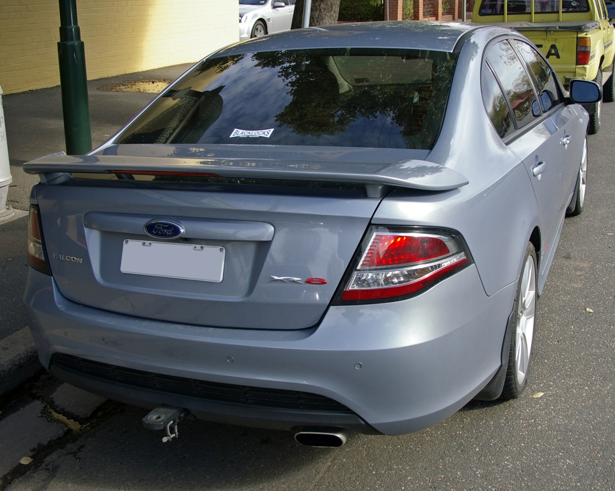 Rear of car with spoiler, distinctive taillights, and single exhaust outlet