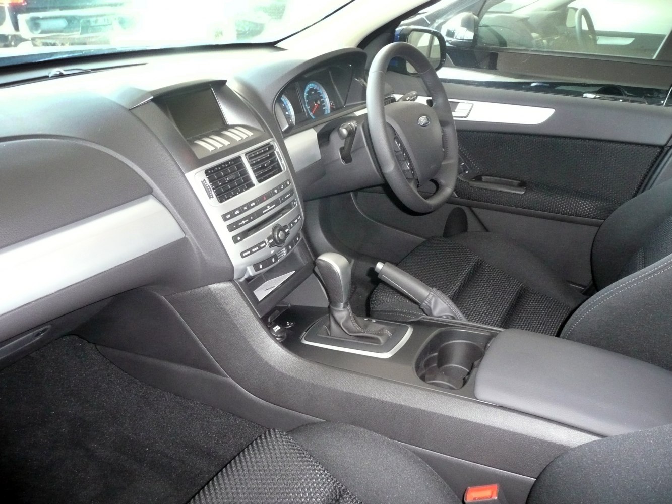 Dashboard with digital gauges and automatic gear shift in a modern car interior