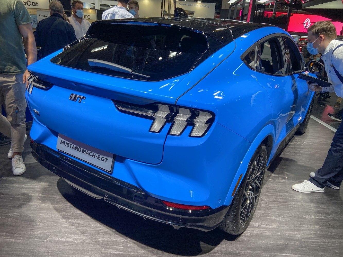 Rear view of electric SUV with triple-bar taillights and spoiler