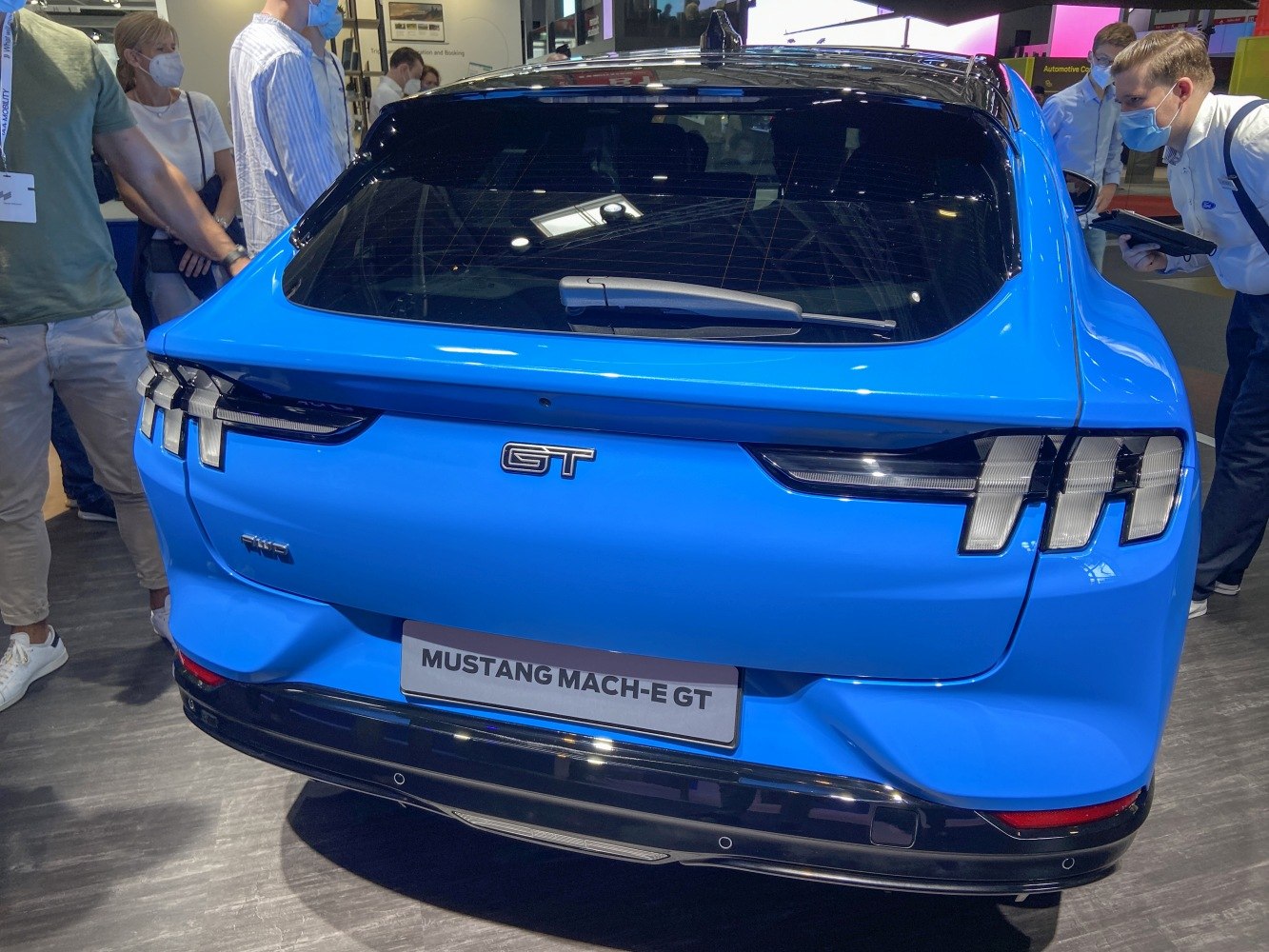 Rear view with distinctive vertical taillights and GT badge on blue electric SUV